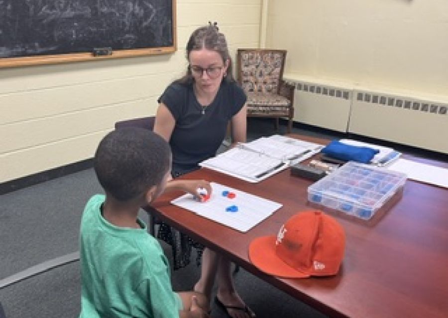 Savannah Braden helps student with reading.
