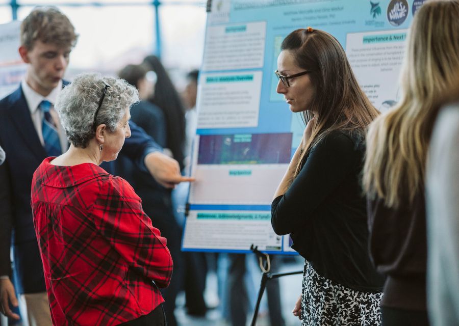 Two woman looking at a poster.