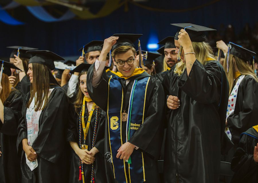 Students turn their tassels.