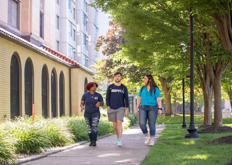 Group of students walking on campus.