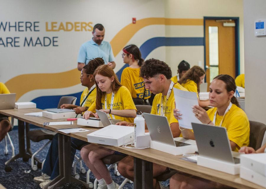 Photo of first-year students receiving their new MacBook Airs