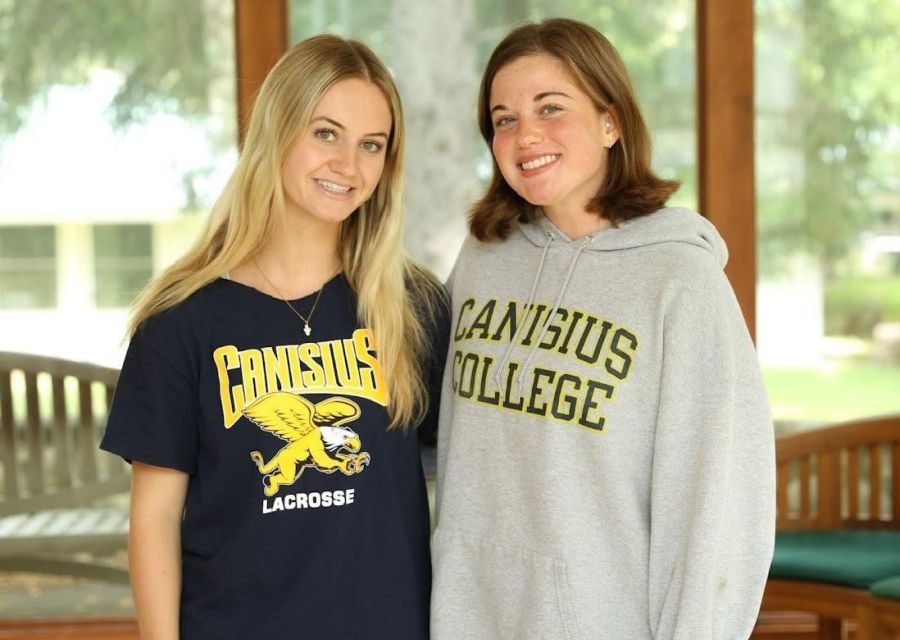 Two female students in Canisius University gear.