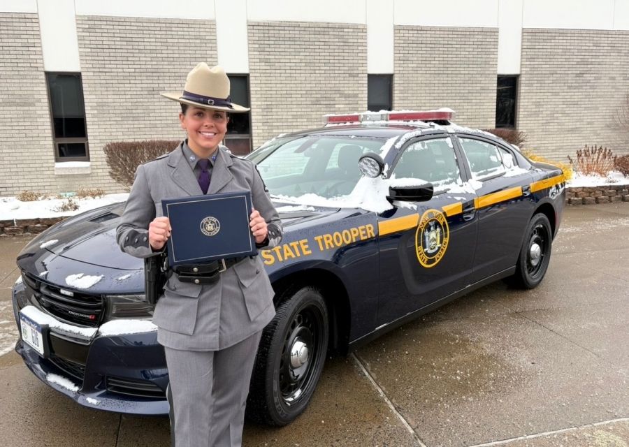 Jill Galanti stands in front of a New York State Trooper vehicle.