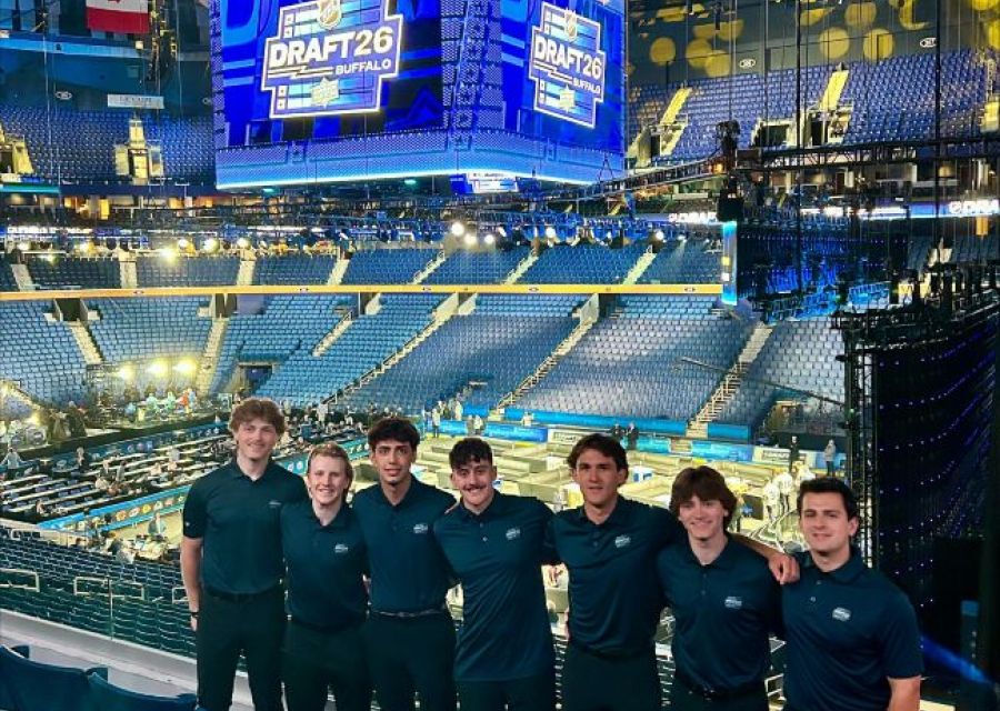Students standing in front of sign at KeyBank Center