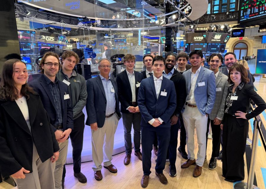 Students and faculty standing on floor of the New York Stock Exchange