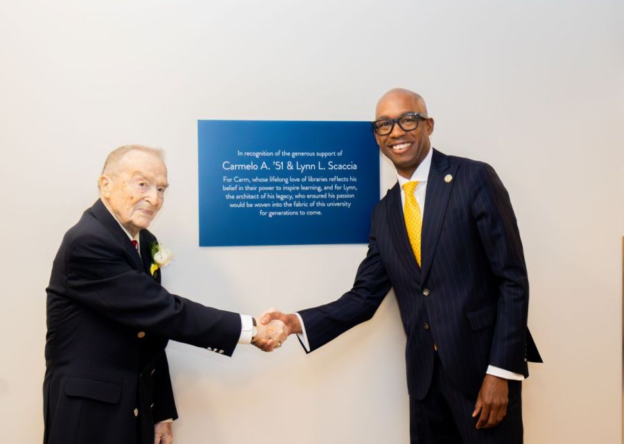 President Stoute shakes hands with Carmello Scaccia at dedication ceremony in Golisano Center for Student Success 