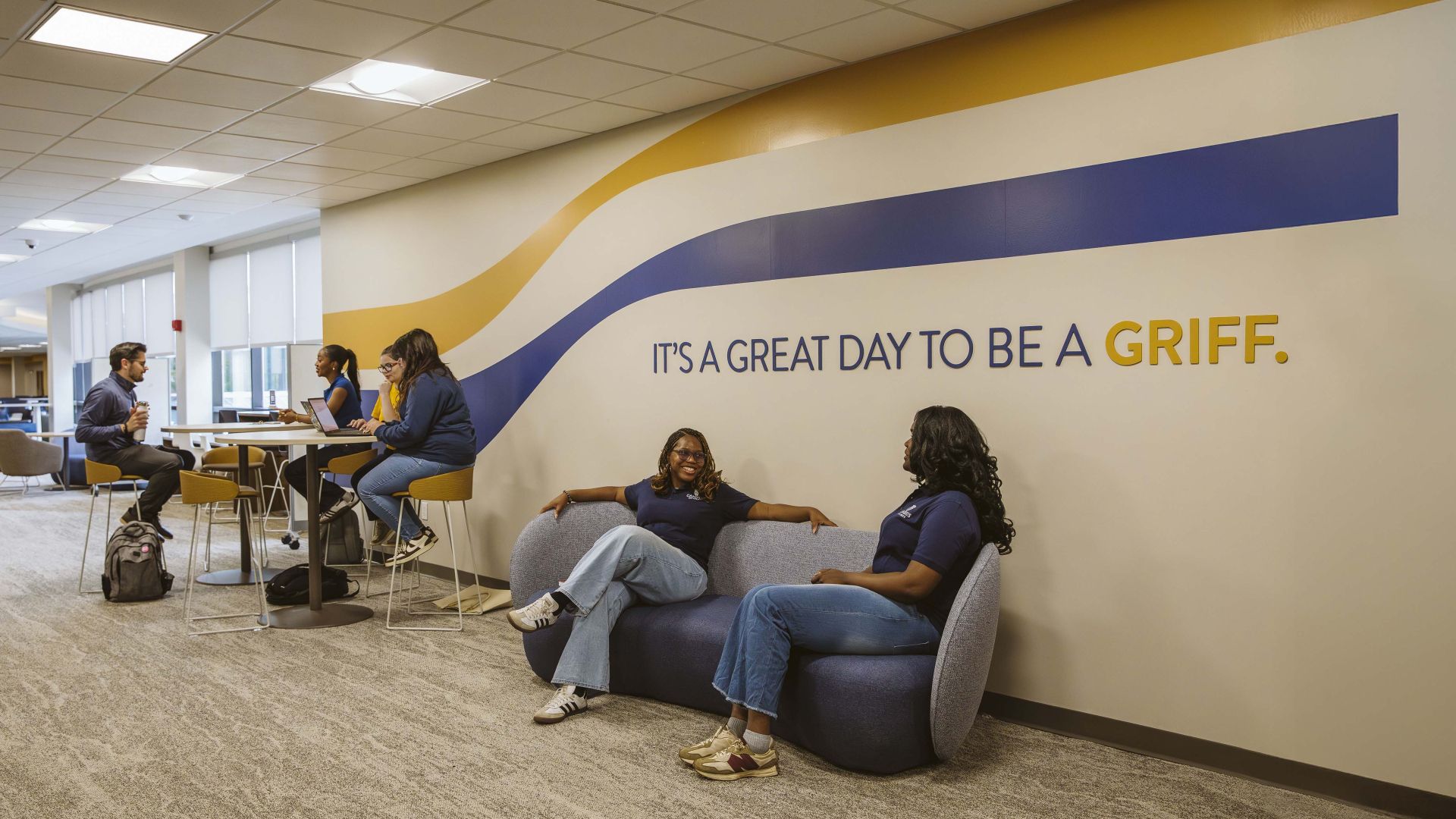 Students gathered in a shared space in a college talking 