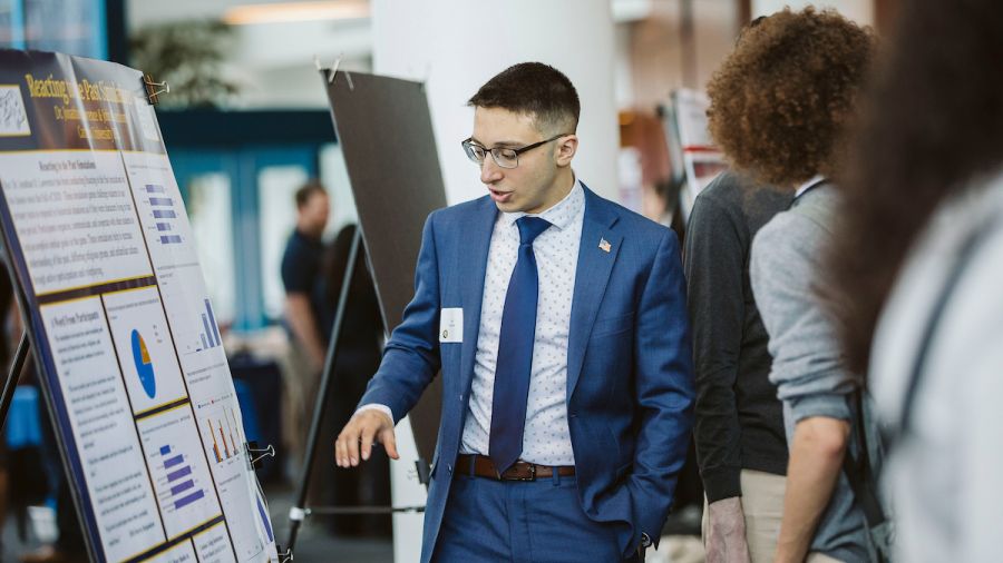 Student in front of a poster