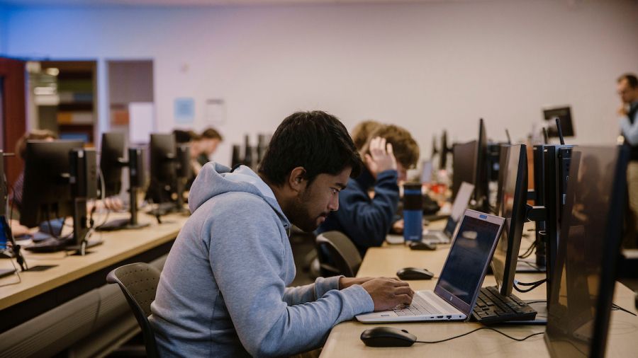 student at a computer in a large college computer lab 