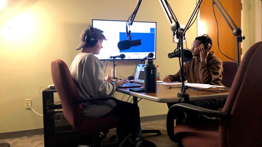 Grace Coloney and Daunte Briggs recording in the podcast studio.