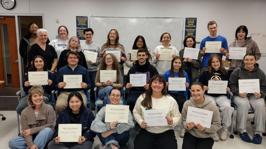 Canisius students holding their mercy doula certificates.