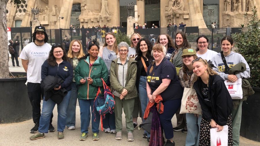 A group of students standing in front of a church.