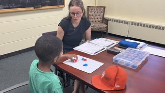 Savannah Braden helps student with reading.