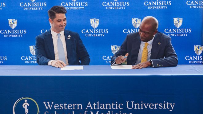 President Steve Stoute signs letter of agreement with representative from Western Atlantic University School of Medicine to partner on a new, accelerated BS-MD program 