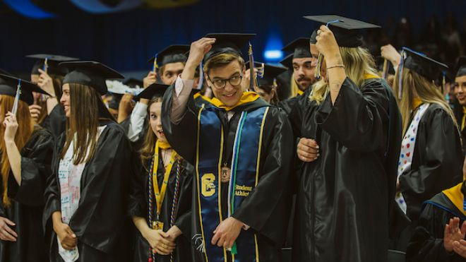 Students turn their tassels.
