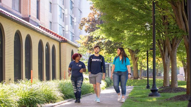 Group of students walking on campus.