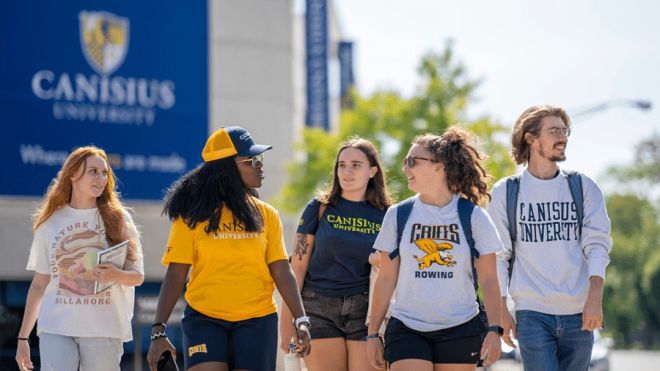 Group shot of canisius university students walking on campus 