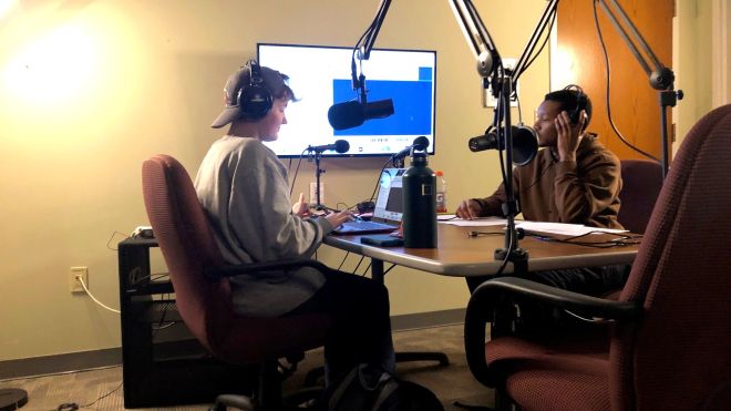 Grace Coloney and Daunte Briggs recording in the podcast studio.