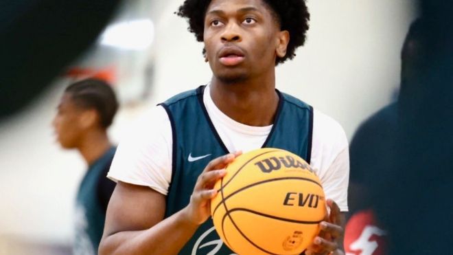 Men's basketball player dribbling a basketball. 