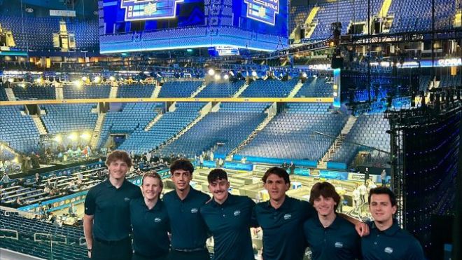 Students standing in front of sign at KeyBank Center