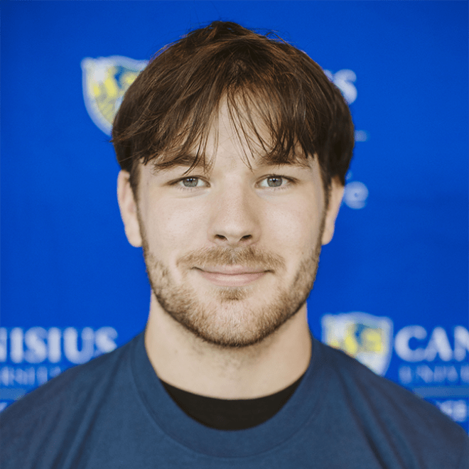 student headshot in front of a college branded background 