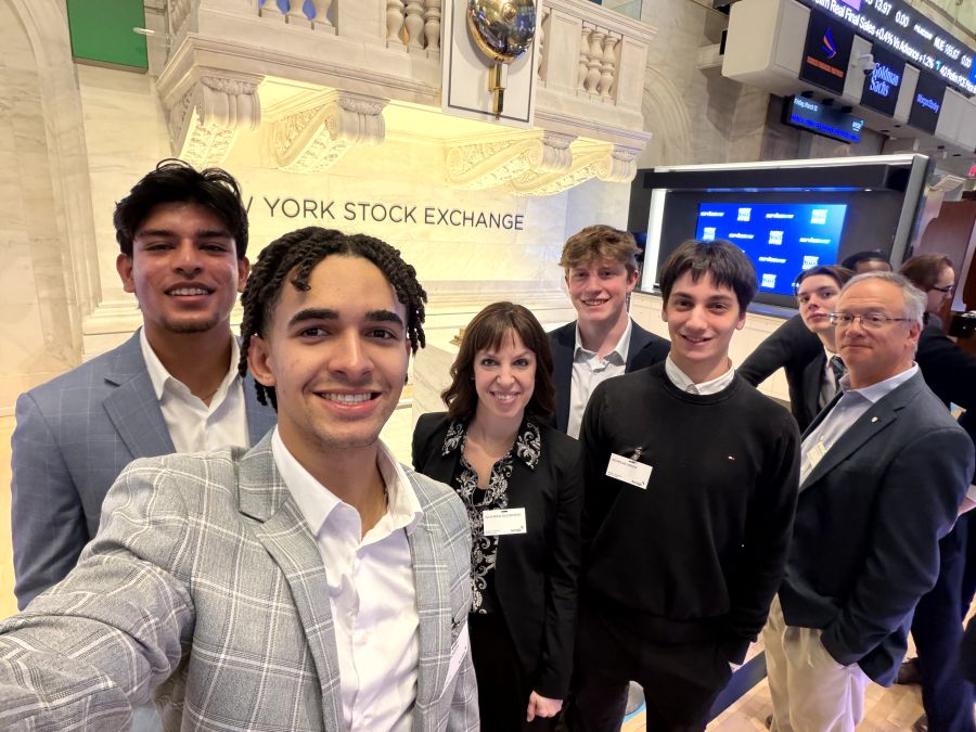 Economics and finance students take a selfie on the floor of the New York Stock Exchange