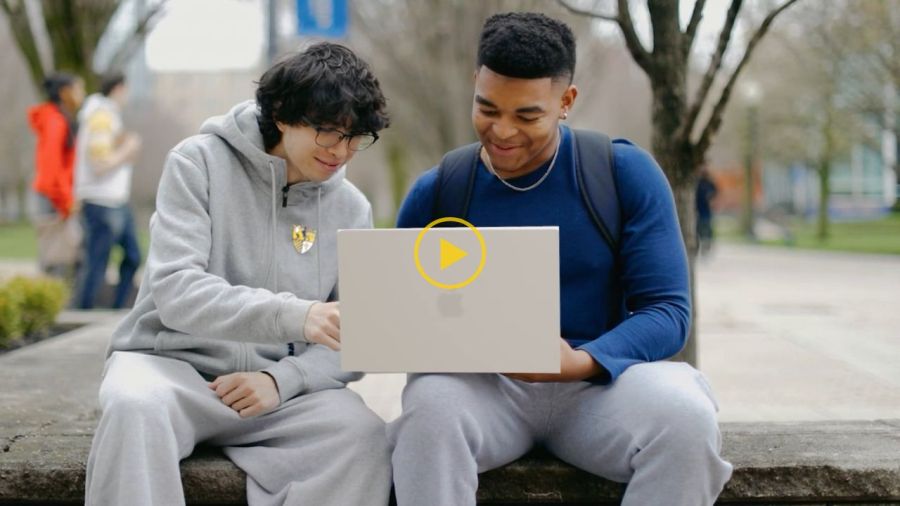 Photo of two Canisius students working on laptop
