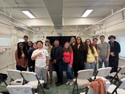 Students gather at Casa Papa Francisco, the hospitality house where they stayed, with former U.S. Border Patrol officer Michael DeBruhl following his presentation.