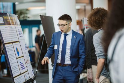 Student in front of a poster