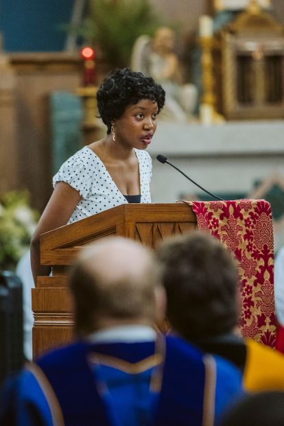 Student delivers a reading from the alter during Mass of the Holy Spirit