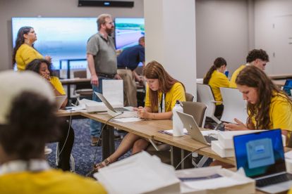 Students set up their new MacBook Air laptops.