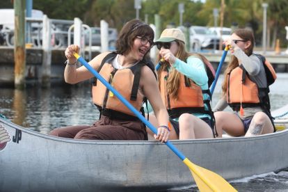 Three people in a canoe.
