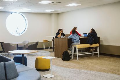 Students sitting at a desk together.