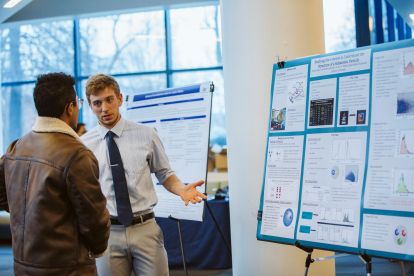 Student presenting poster at Ignatian Scholarship Day