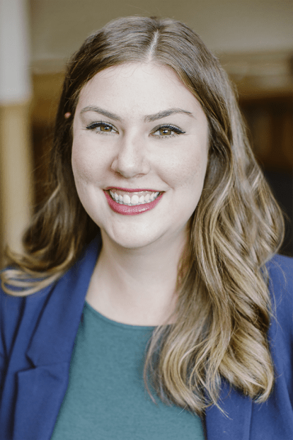 professor posing for a headshot against a wall