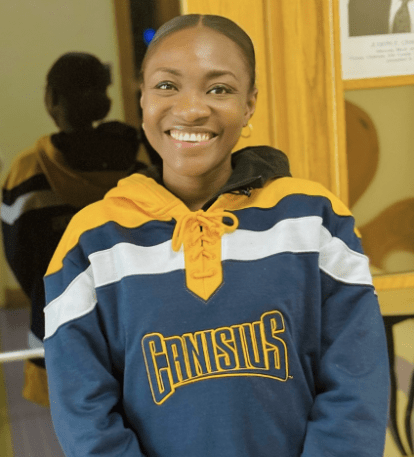 student posing for a headshot in a canisius sweater