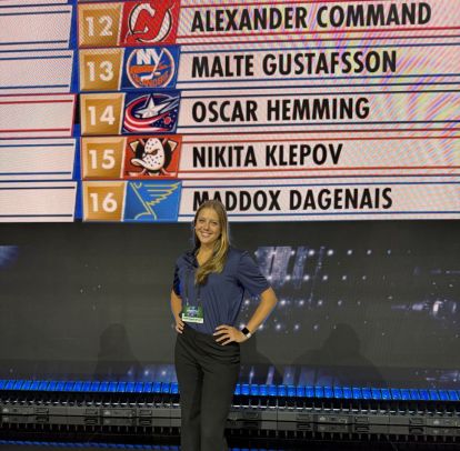 Student in front of names at the 2026 NHL Draft.
